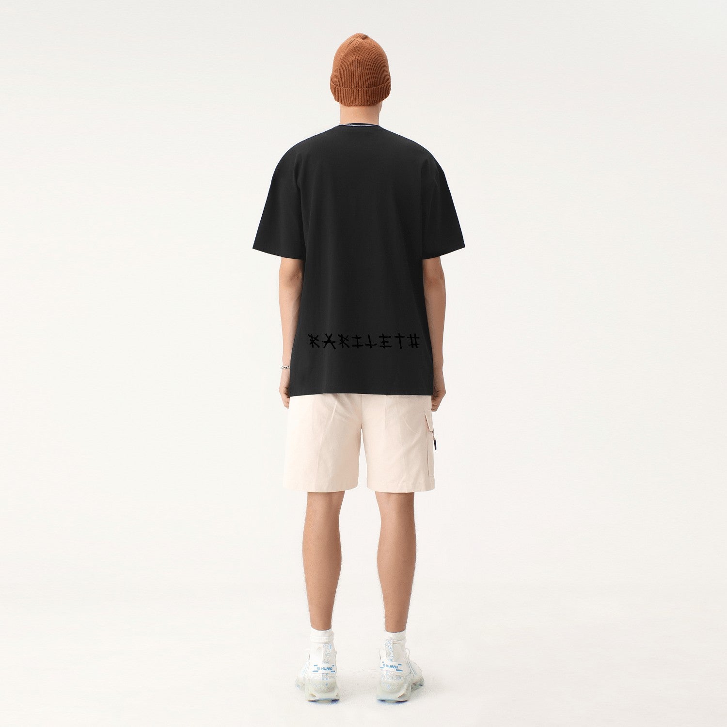 GLOWING MEN Drop Shoulder Short Sleeve Unisex T-shirt - Black - Back View on Model - Rarileto