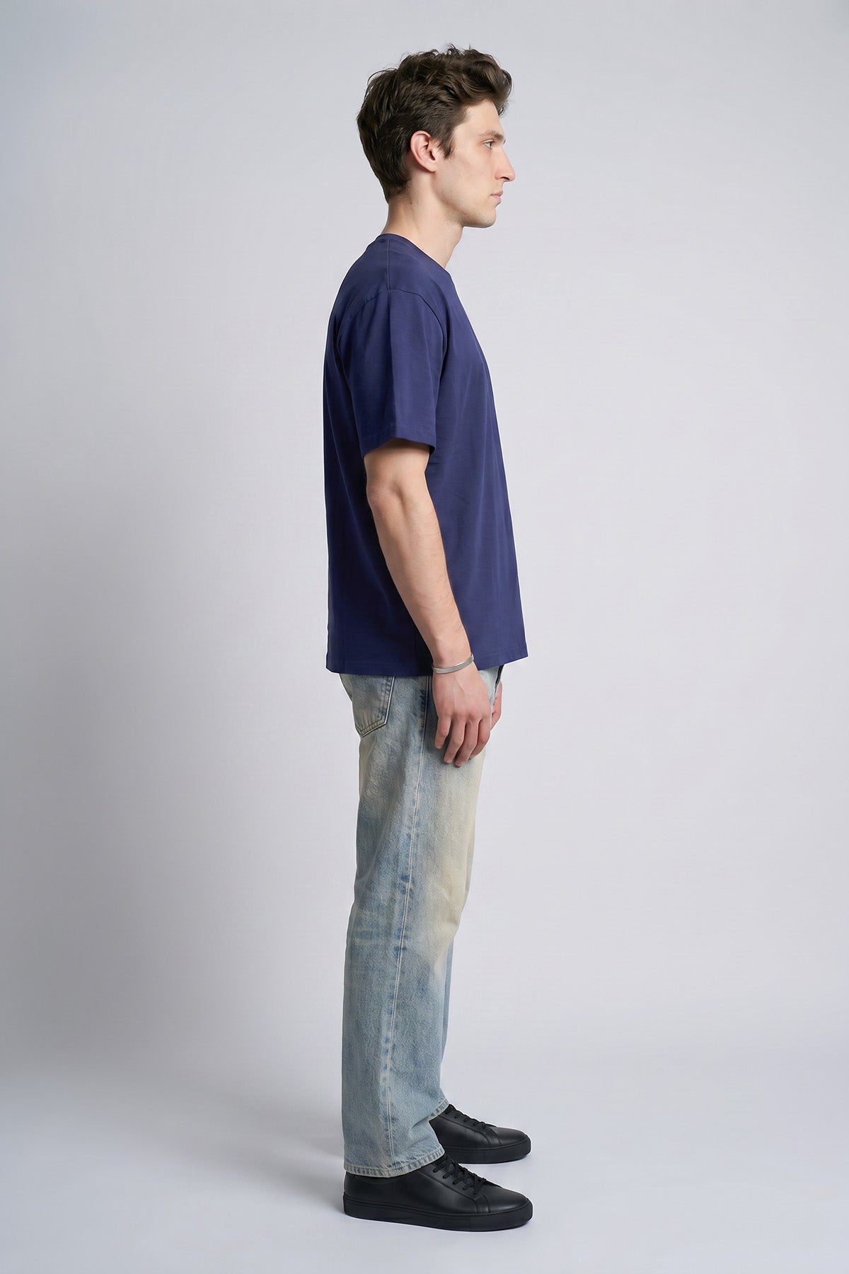 Navy male model side view — RARILETO Left Logo Classic Tee