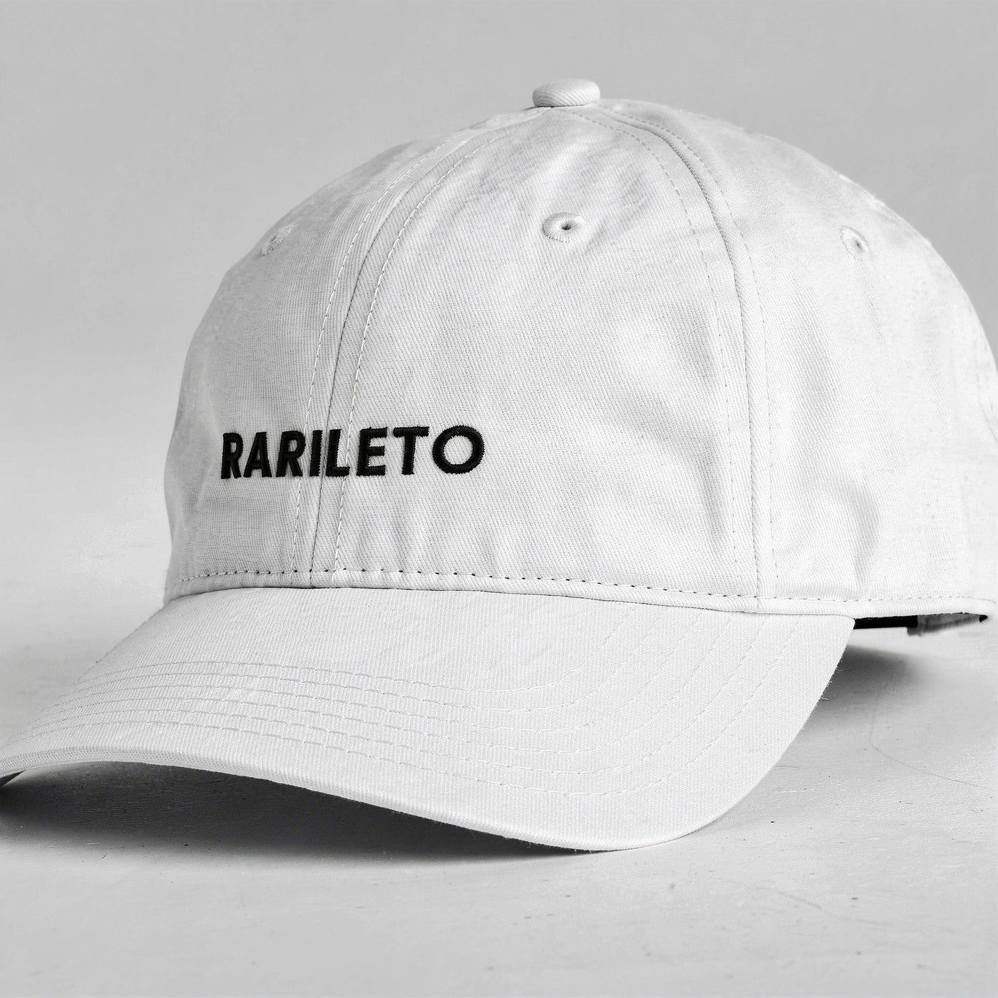 White cap side view RARILETO Wordmark Cap — Unstructured Strapback