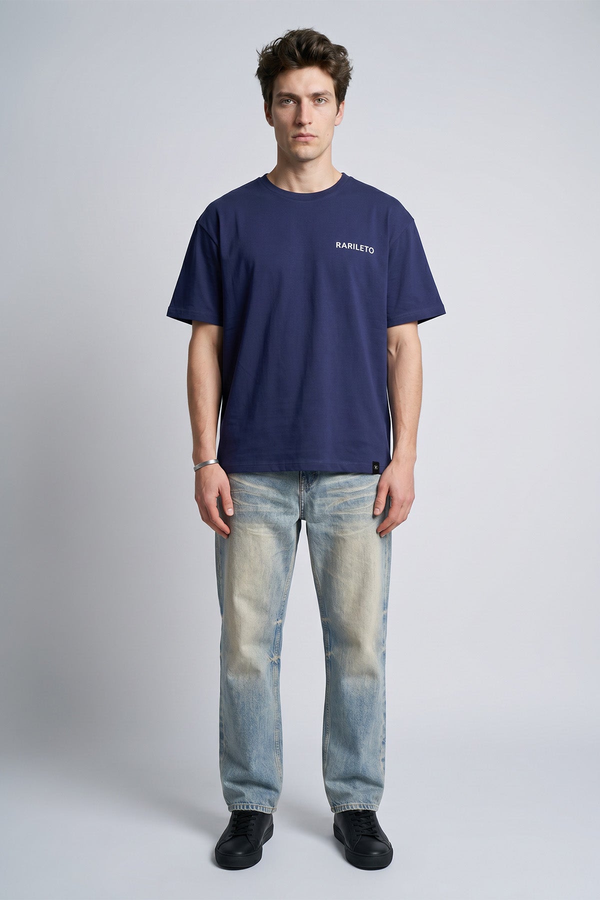 Navy male model wearing front view — RARILETO Left Logo Classic Tee